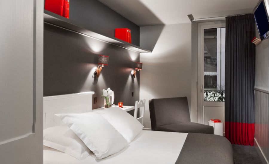 comfortable triple room with grey walls and red decoration details