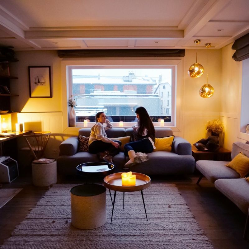 Young women chatting on the living room sofa