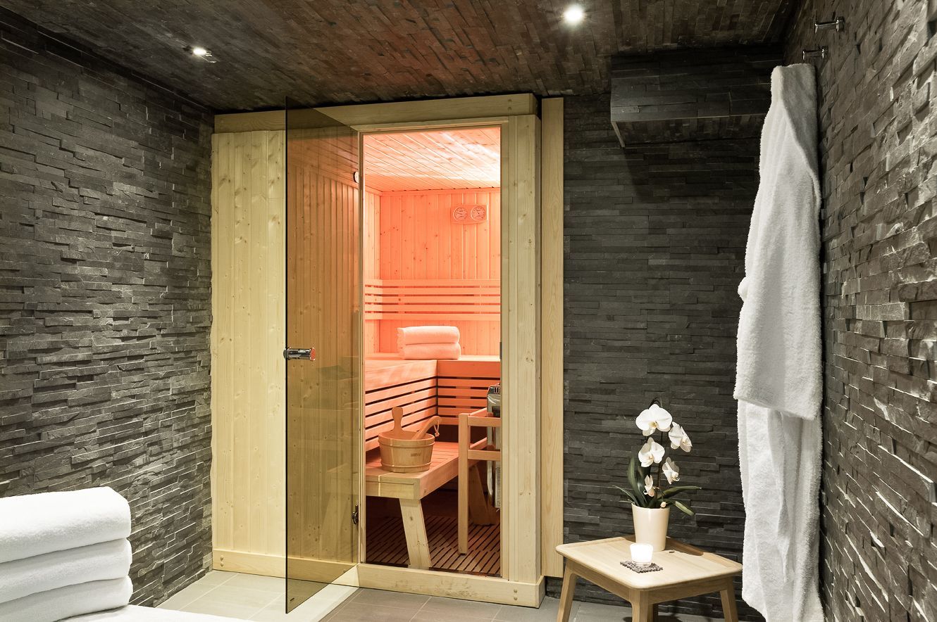 Mur en pierre et cabine de sauna dans le spa hôtel Faucigny