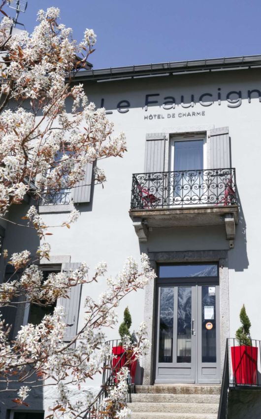 Flower-filled entrance to Le Faucigny hotel in spring